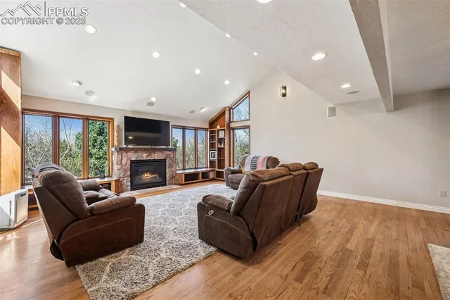 a living room with furniture a fireplace and a flat screen tv