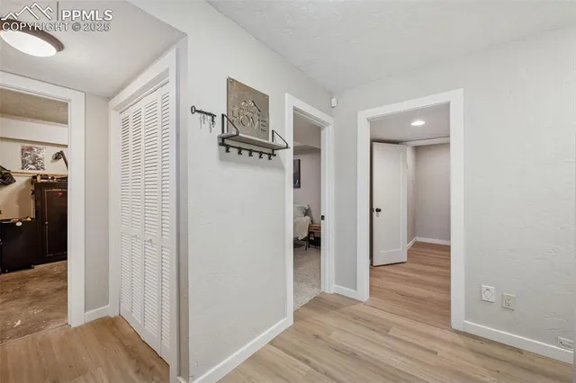 a view of hallway with wooden floor