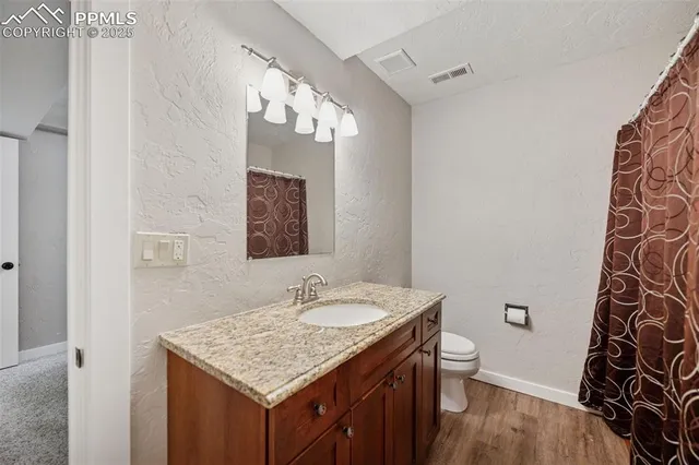 a bathroom with a sink vanity and a mirror