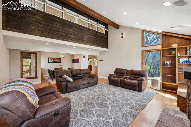 a living room with furniture ceiling fan and a rug