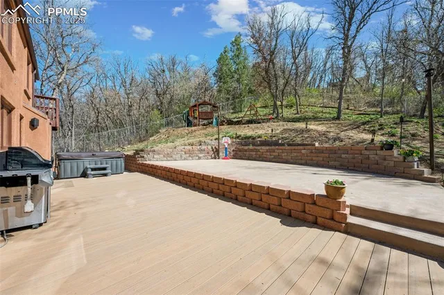 a view of a yard with wooden fence