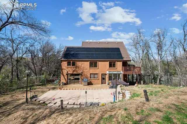a front view of a house with a yard covered with snow