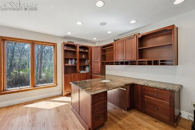 a kitchen with stainless steel appliances granite countertop a stove and a wooden cabinets