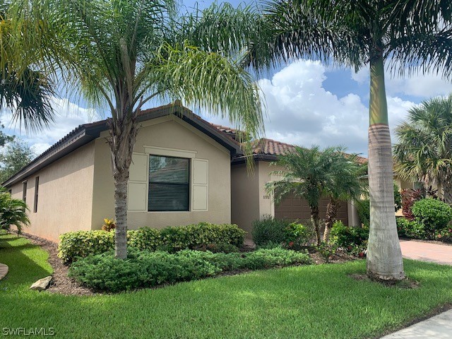 8976 Water Tupelo Road Fort Myers, FL 33912 - Photo 1 of 35 a front view of house with yard and green space