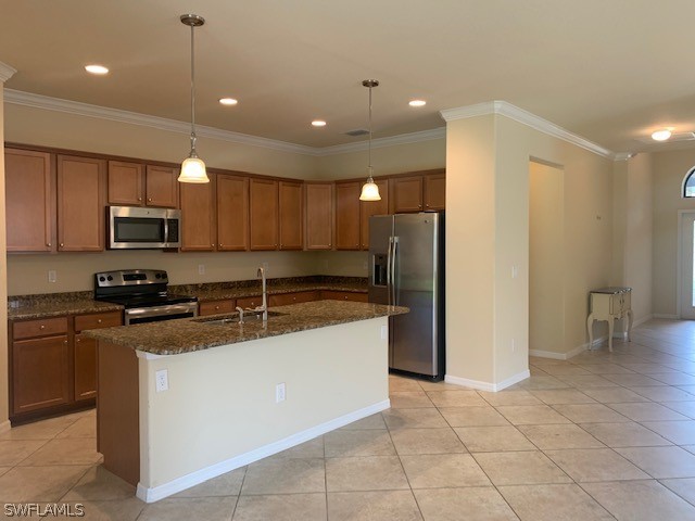 8976 Water Tupelo Road Fort Myers, FL 33912 - Photo 11 of 35 a kitchen with stainless steel appliances granite countertop a sink and a refrigerator