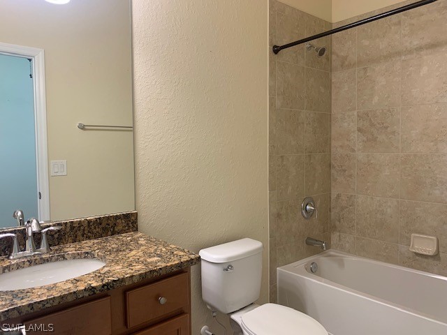 8976 Water Tupelo Road Fort Myers, FL 33912 - Photo 22 of 35 a bathroom with a granite countertop sink toilet and shower