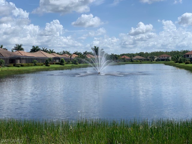 8976 Water Tupelo Road Fort Myers, FL 33912 - Photo 34 of 35 a view of a lake in front of a building