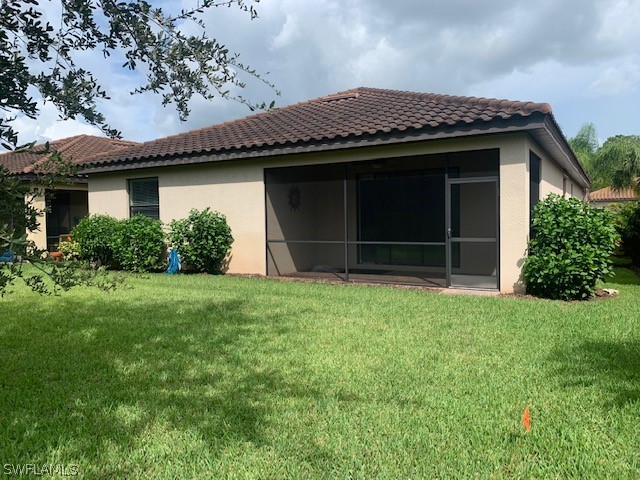 8976 Water Tupelo Road Fort Myers, FL 33912 - Photo 4 of 35 front view of a house with a garden