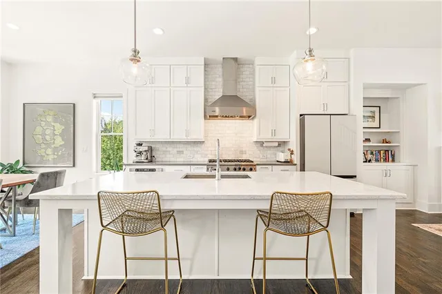 a view of a hallway with wooden floor and entryway