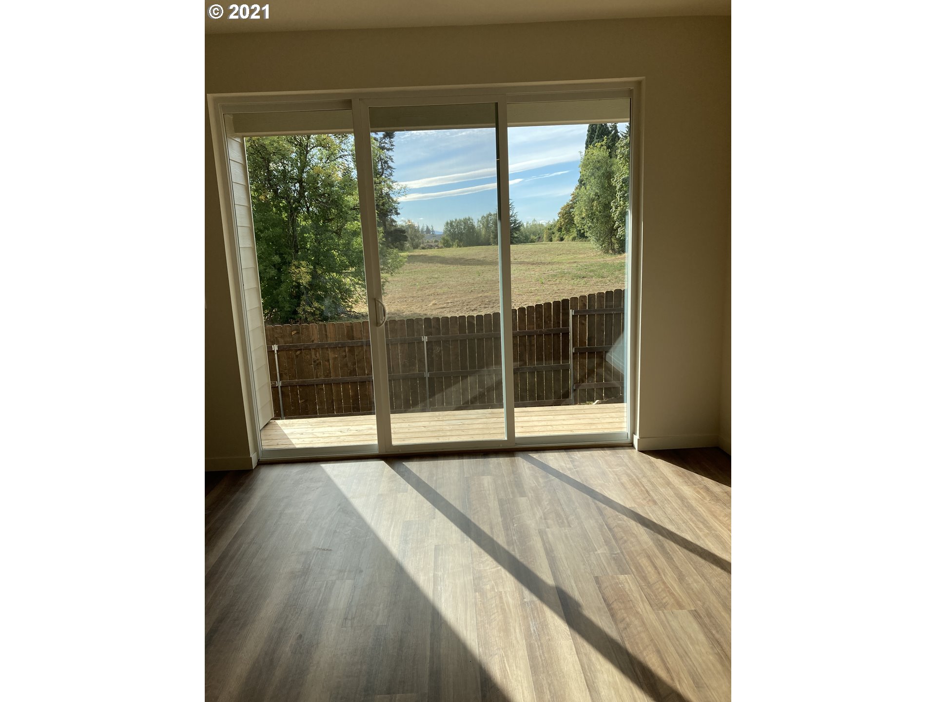 1227 South Union Place Ridgefield, WA 98642 - Photo 4 of 8 a view of an empty room with wooden floor and a window