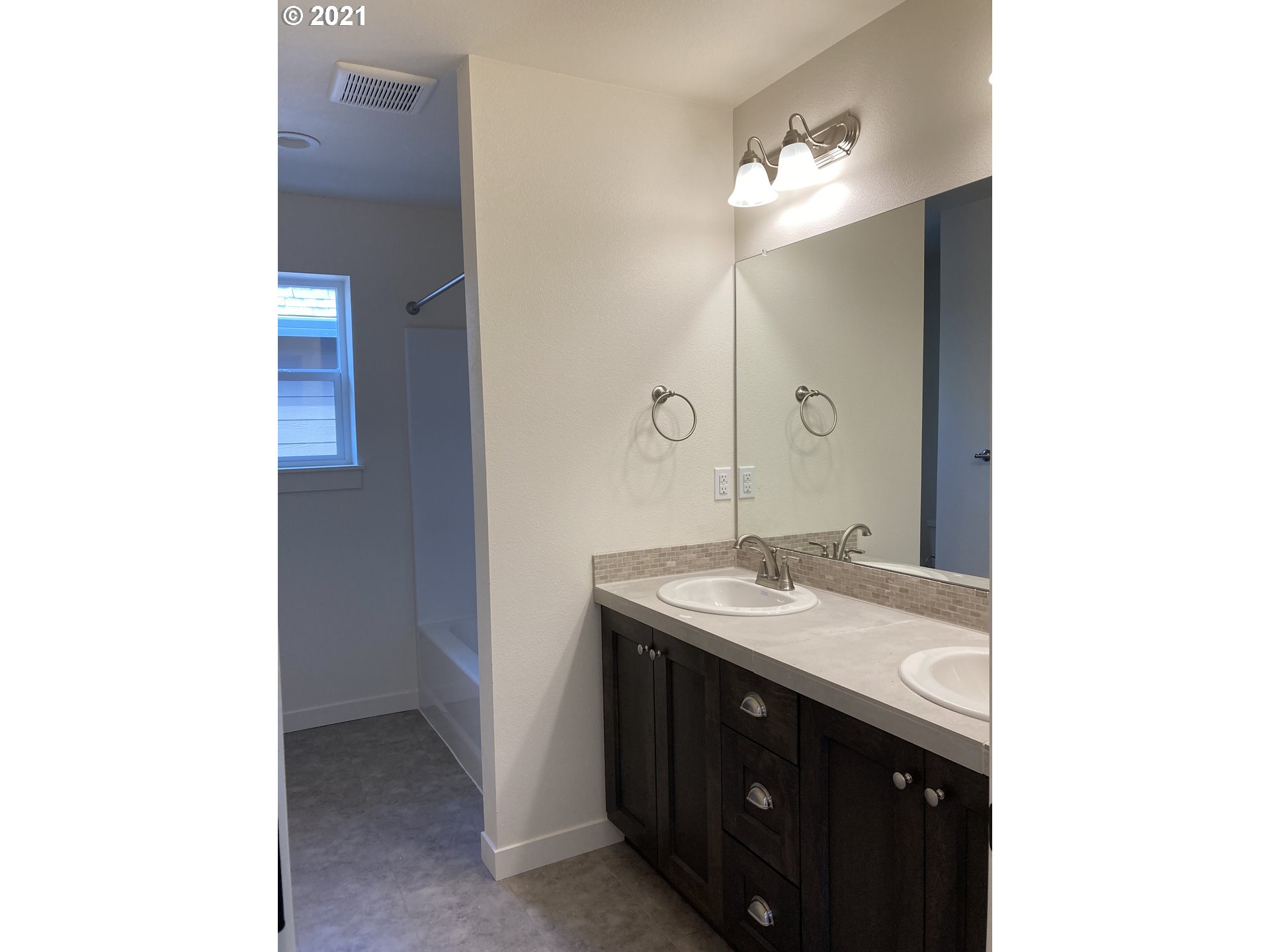1227 South Union Place Ridgefield, WA 98642 - Photo 5 of 8 a bathroom with a granite countertop sink and a mirror