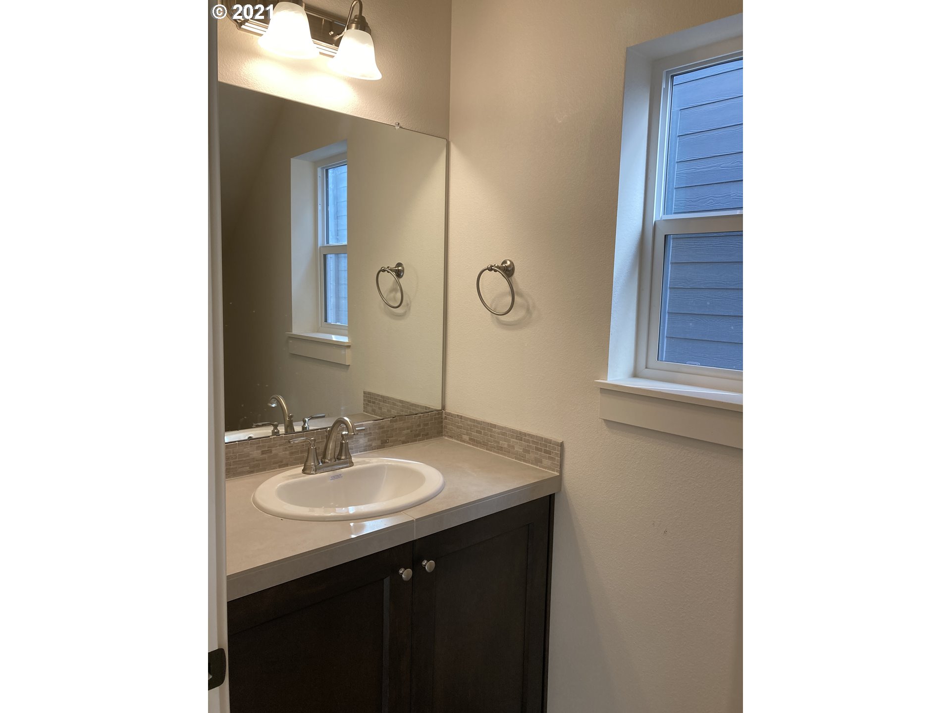 1227 South Union Place Ridgefield, WA 98642 - Photo 8 of 8 a bathroom with a sink and a mirror