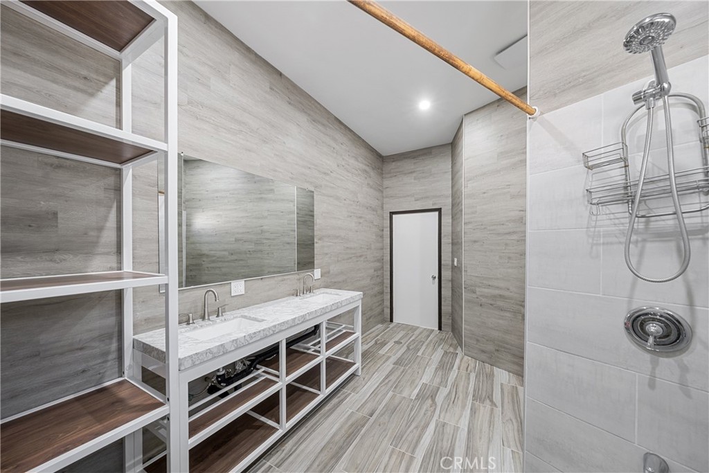 26251 Ravenhill Road Canyon Country, CA 91387 - Photo 15 of 64 a bathroom with a double vanity sink and a mirror