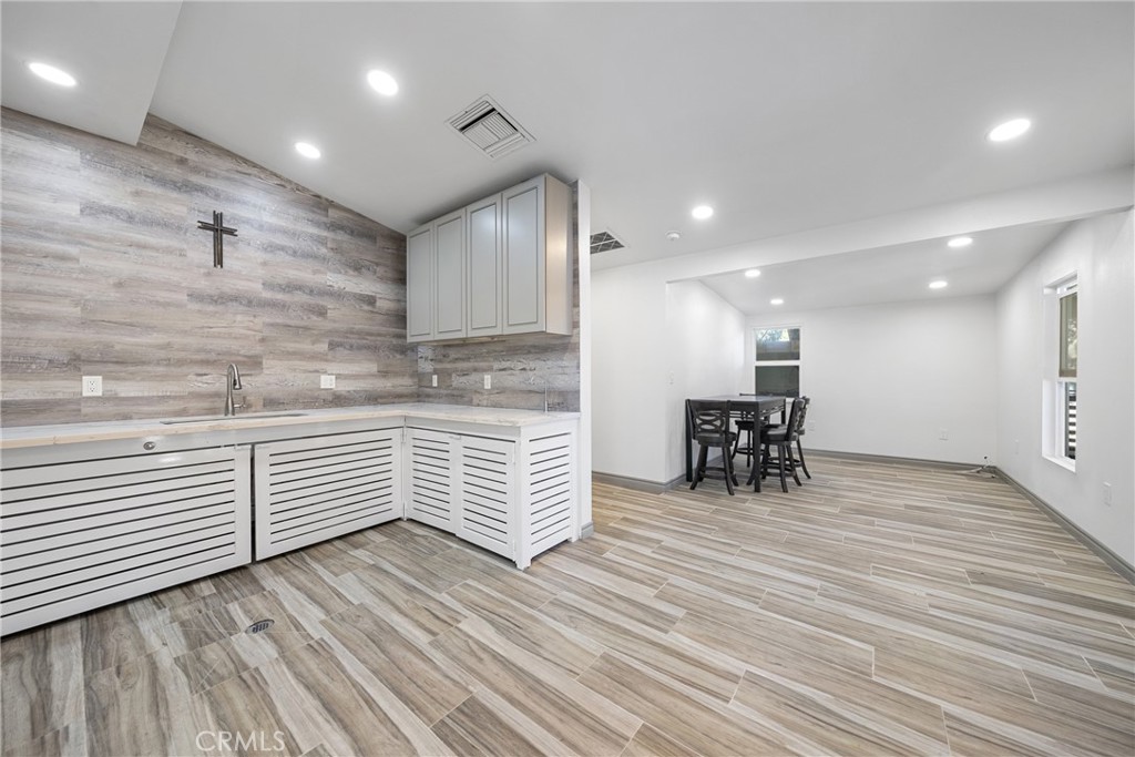 26251 Ravenhill Road Canyon Country, CA 91387 - Photo 19 of 64 a kitchen with stainless steel appliances wooden floor and a large window