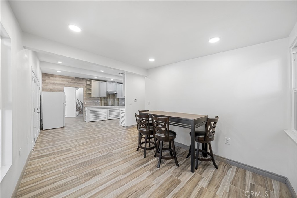 26251 Ravenhill Road Canyon Country, CA 91387 - Photo 21 of 64 a view of a dining room with furniture and wooden floor