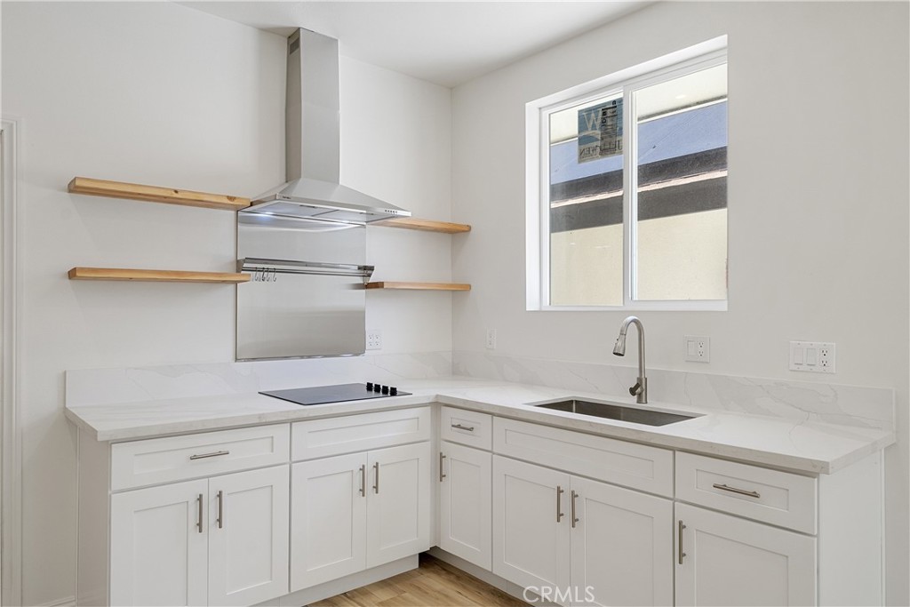 26251 Ravenhill Road Canyon Country, CA 91387 - Photo 33 of 64 a kitchen with cabinets and window