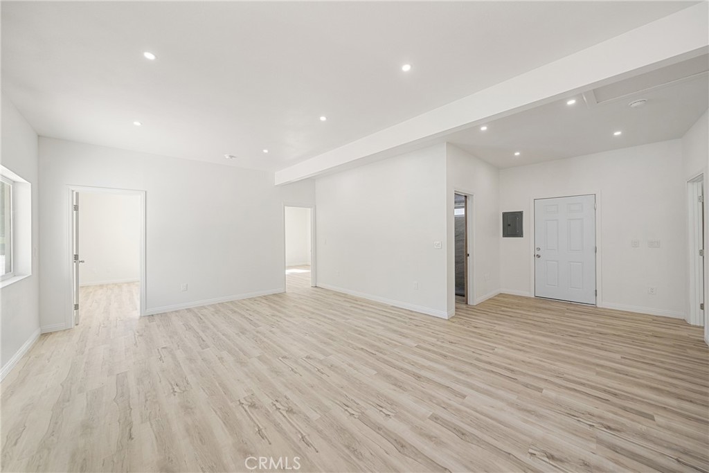 26251 Ravenhill Road Canyon Country, CA 91387 - Photo 36 of 64 a view of an empty room with wooden floor