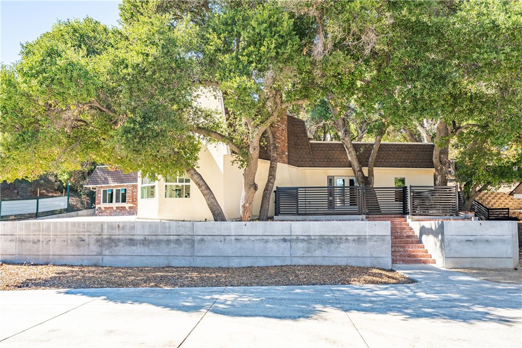 26251 Ravenhill Road Canyon Country, CA 91387 - Photo 53 of 64 front view of a house with a tree