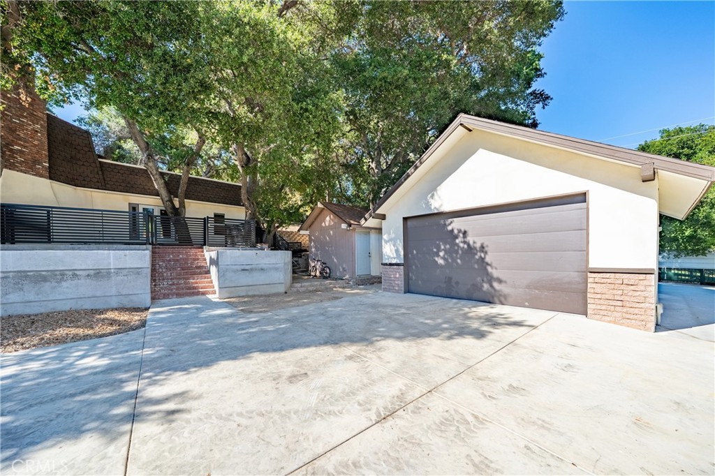26251 Ravenhill Road Canyon Country, CA 91387 - Photo 54 of 64 a front view of a house with a yard and garage