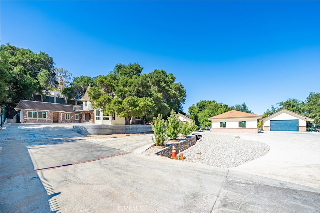 26251 Ravenhill Road Canyon Country, CA 91387 - Photo 57 of 64 front view of a house with a yard