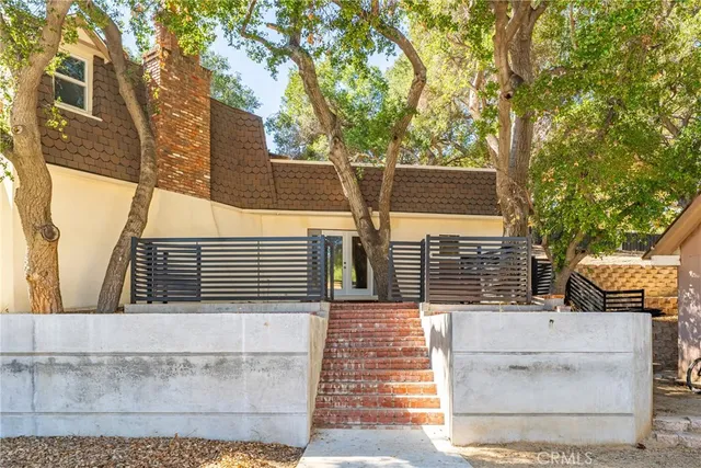 a view of a house with a tree
