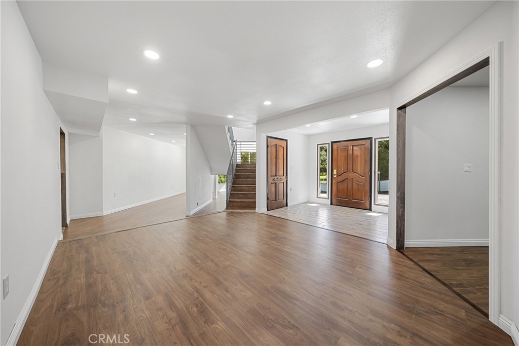 26251 Ravenhill Road Canyon Country, CA 91387 - Photo 10 of 64 a view of an empty room with wooden floor and a window