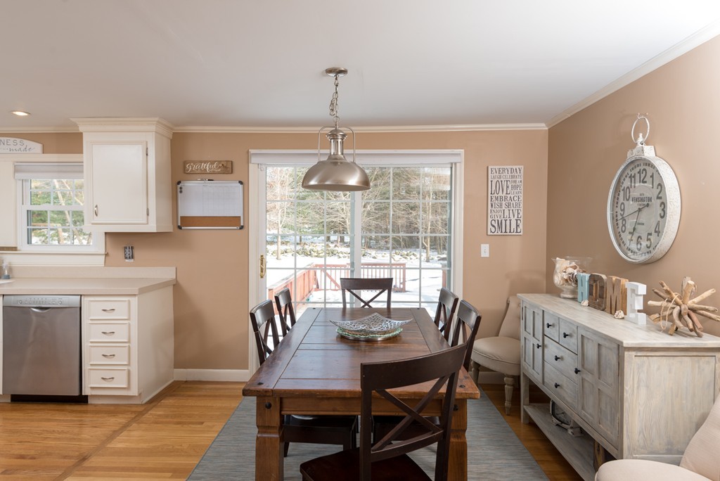 71 Deborah Road Hanover, MA 02339 - Photo 7 of 28 a dining room with wooden floor a chandelier a wooden table and chairs