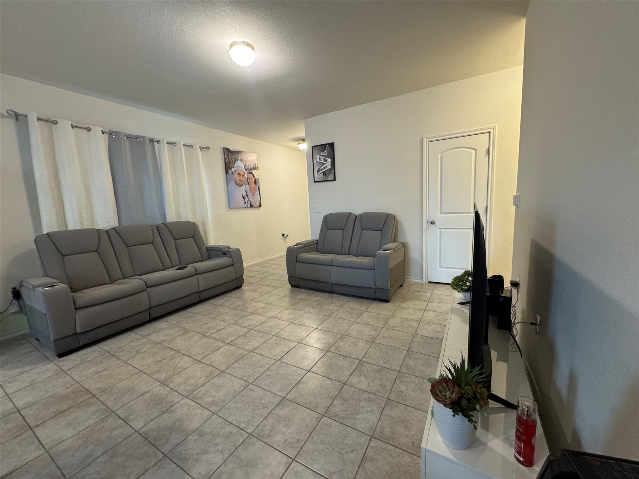 13017 Foreston Drive Austin, TX 78754 - Photo 3 of 12 a living room with furniture and a flat screen tv