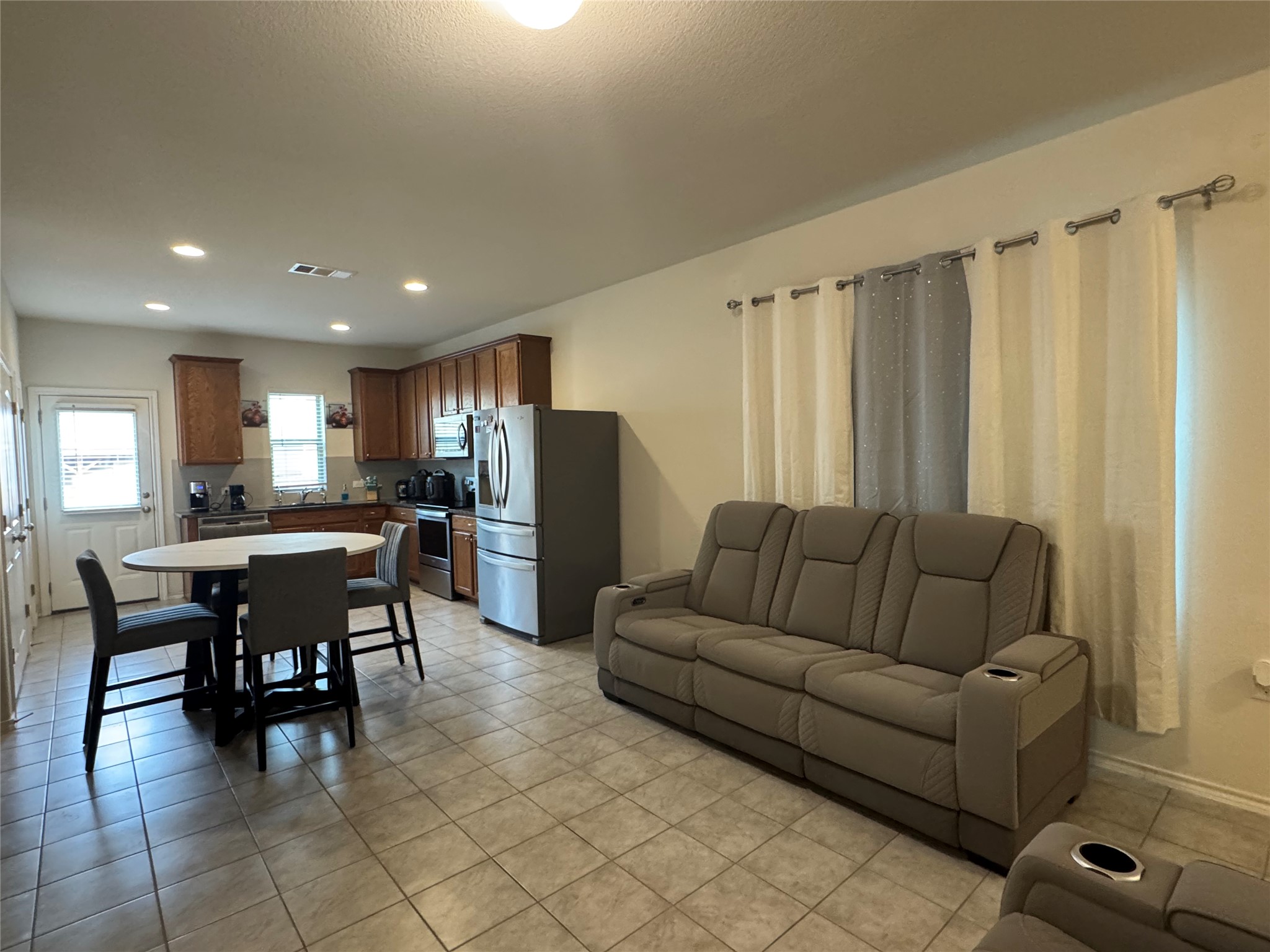 13017 Foreston Drive Austin, TX 78754 - Photo 4 of 12 a living room with furniture and a dining table with kitchen view