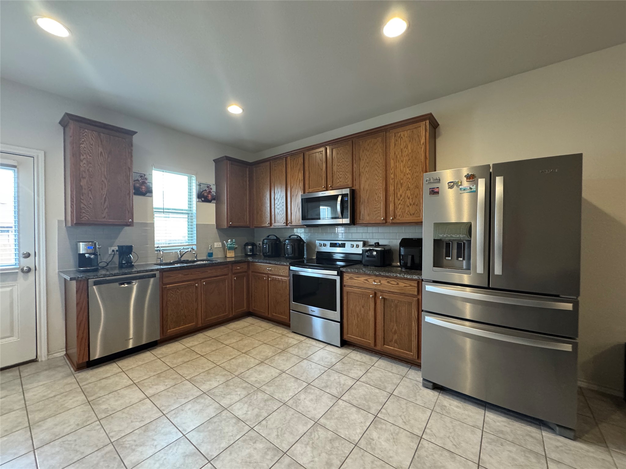 13017 Foreston Drive Austin, TX 78754 - Photo 5 of 12 a kitchen with granite countertop stainless steel appliances and white cabinets