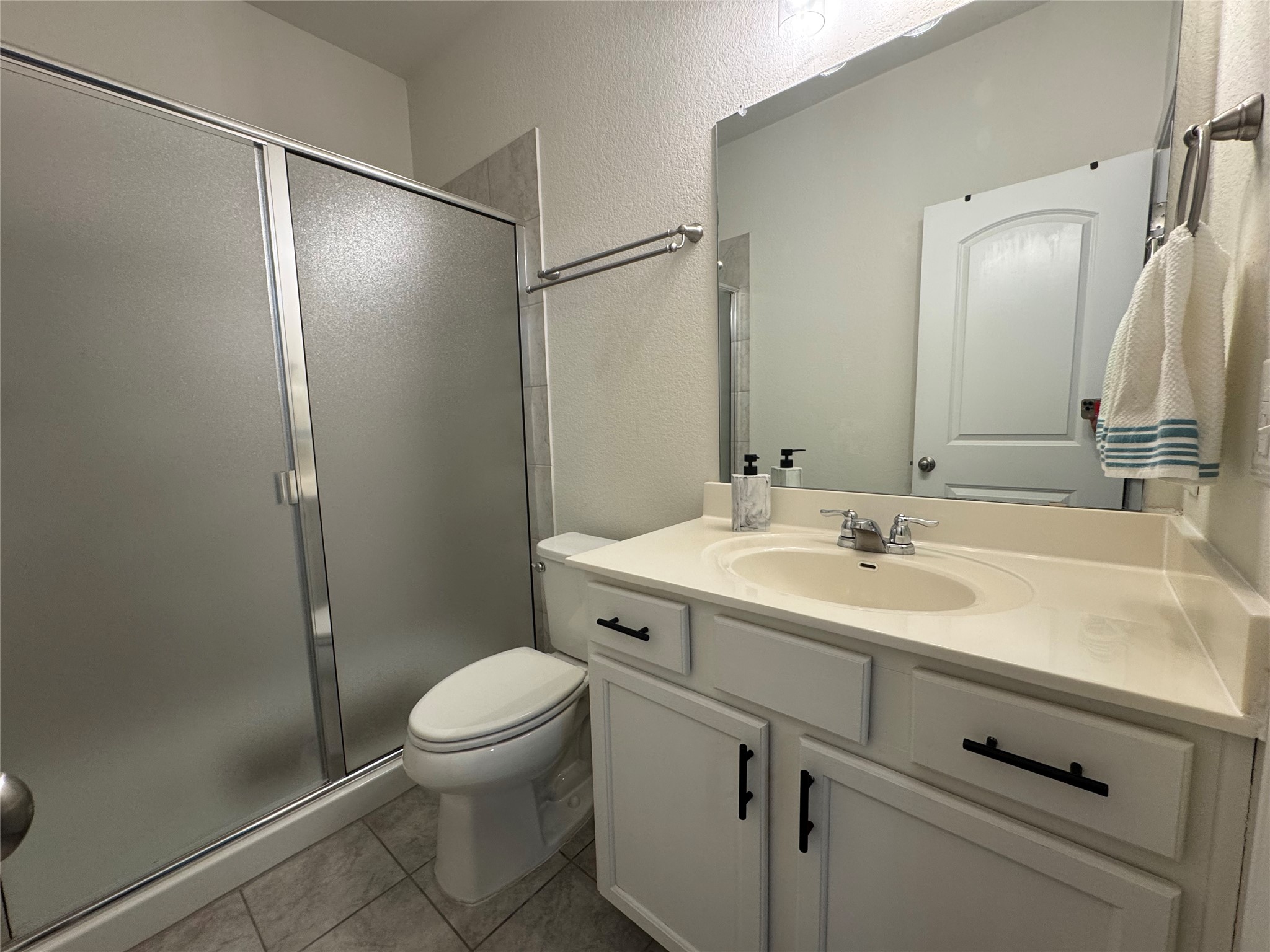 13017 Foreston Drive Austin, TX 78754 - Photo 8 of 12 a bathroom with a sink toilet vanity and shower