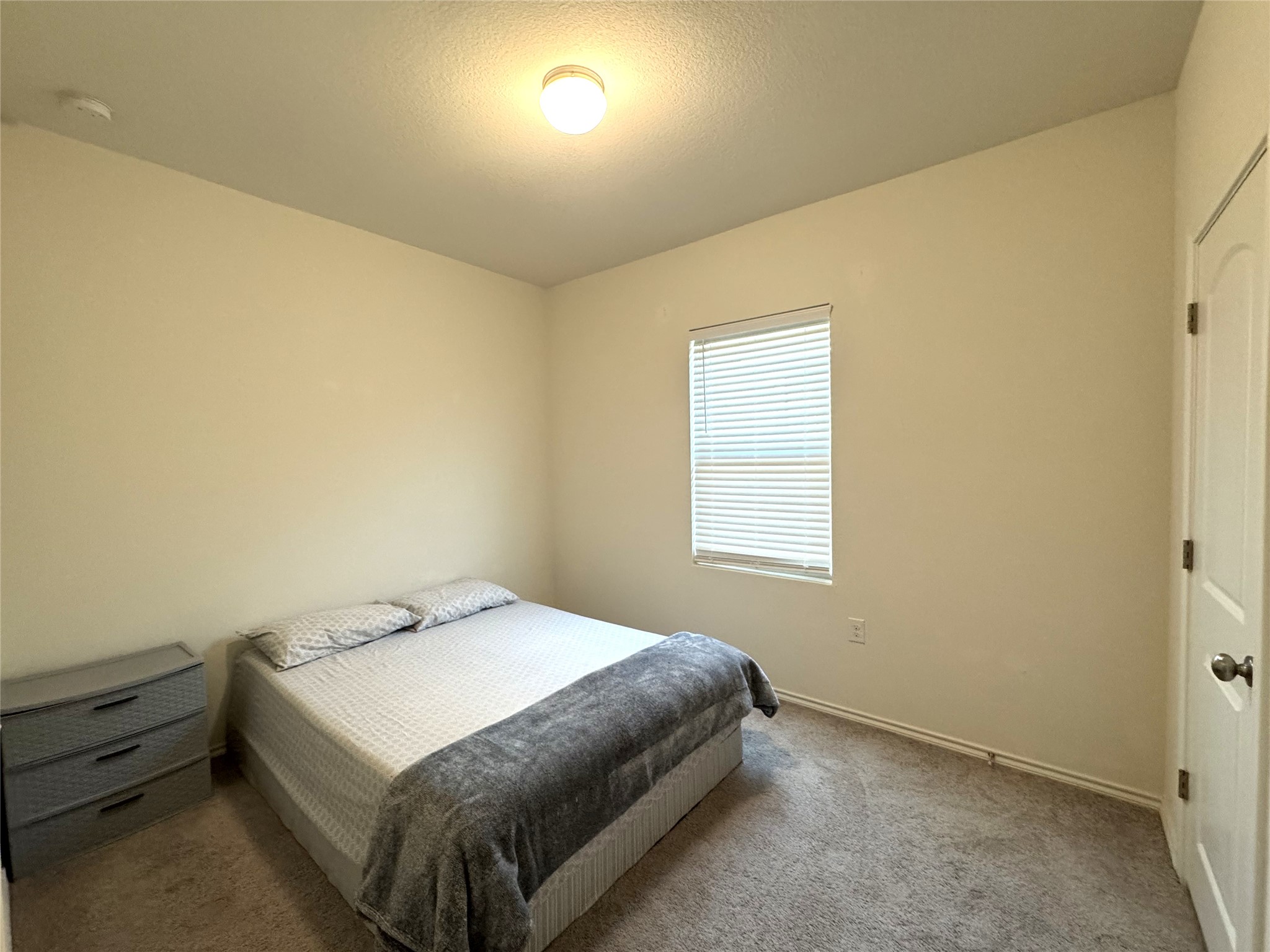 13017 Foreston Drive Austin, TX 78754 - Photo 9 of 12 a bedroom with a bed and a window