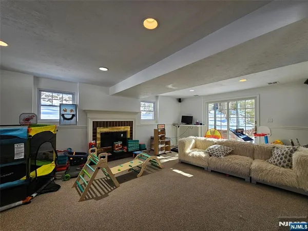 a living room with furniture a fireplace and a flat screen tv