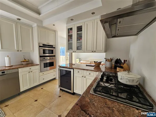 a kitchen with sink a stove and cabinets