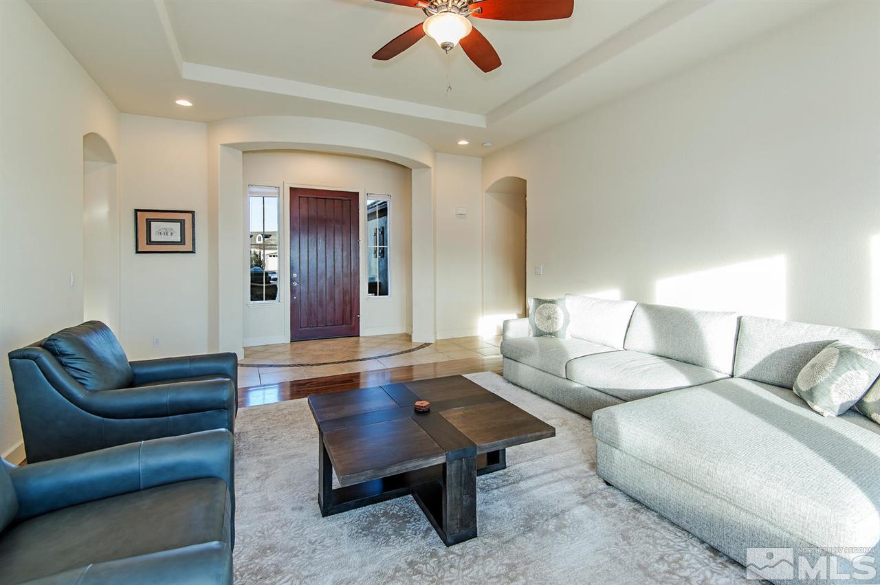 6965 Cour Street Reno, NV 89511 - Photo 2 of 25 a living room with furniture and a chandelier