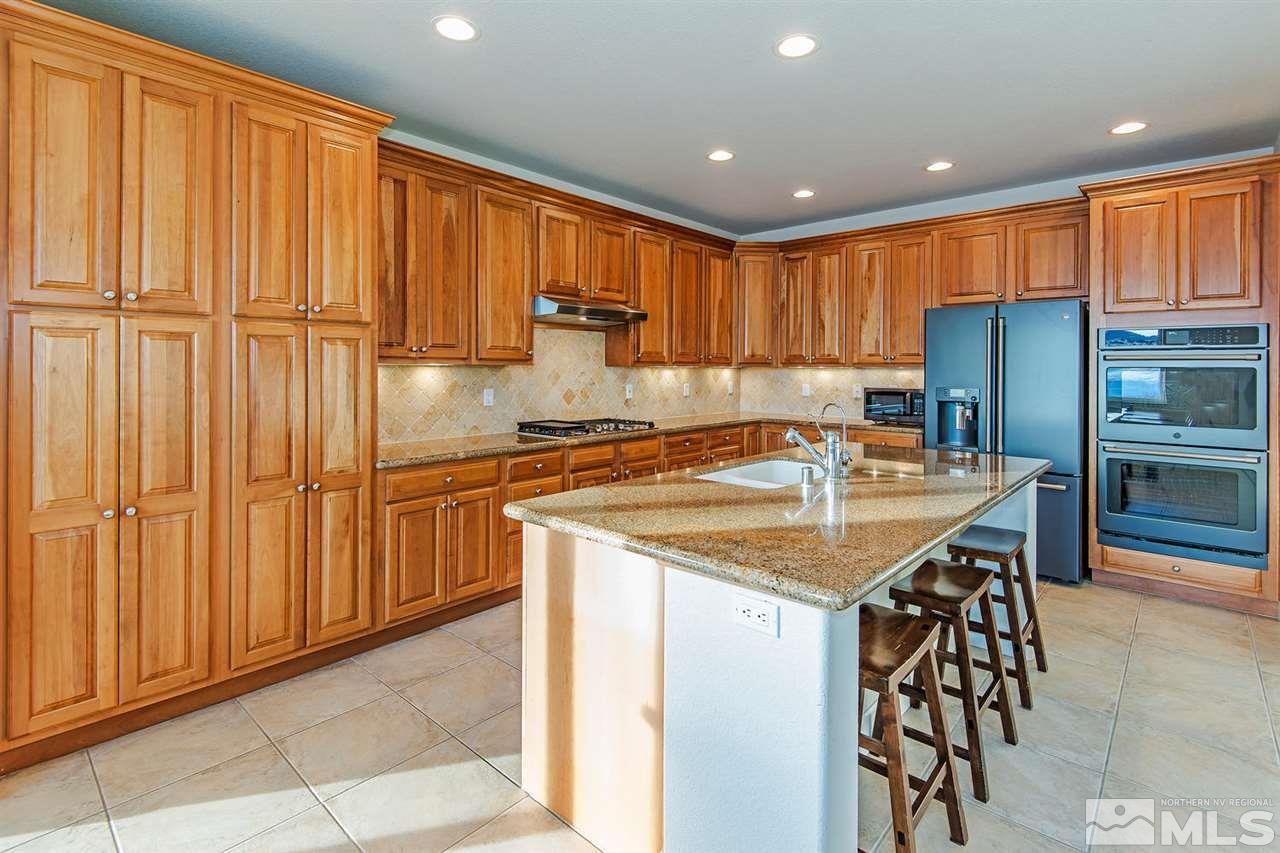 6965 Cour Street Reno, NV 89511 - Photo 6 of 25 a kitchen with stainless steel appliances granite countertop a sink and a refrigerator