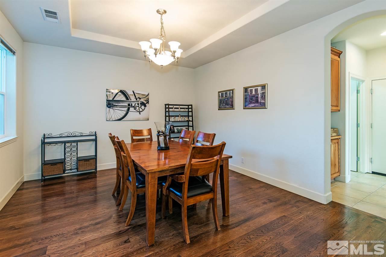 6965 Cour Street Reno, NV 89511 - Photo 7 of 25 a view of a dining room with furniture wooden floor and chandelier