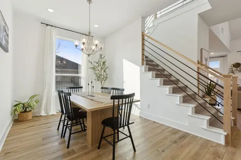 a view of a dining room with furniture window and wooden floor