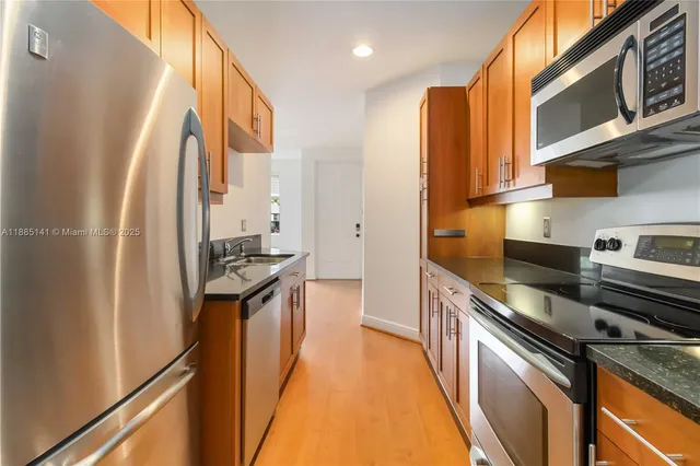 a kitchen with stainless steel appliances a stove a microwave and cabinets
