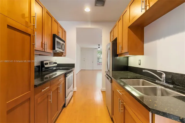 an empty room with a window and a ceiling fan
