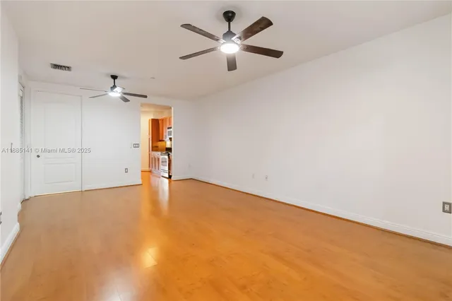 an empty room with fan and ceiling fan