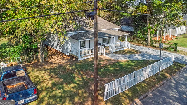 a view of a house with wooden fence