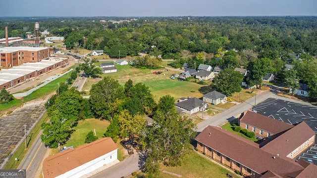 an aerial view of residential houses with outdoor space