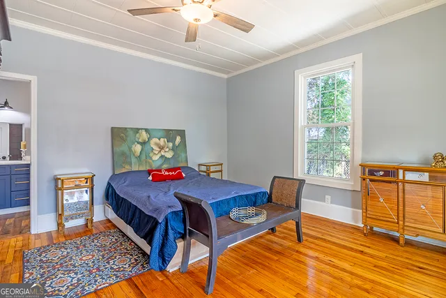 a dining room with wooden floor and furniture