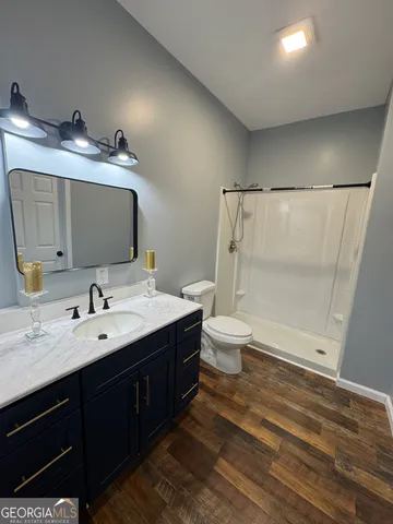 a bathroom with a double vanity sink toilet and mirror