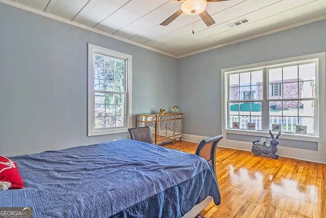 a spacious bedroom with a bed and a large window