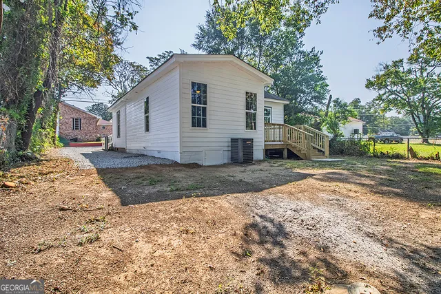 a view of a yard with a house and a large tree