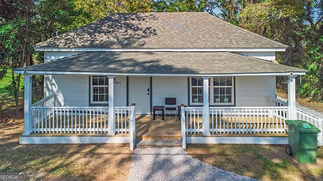 an outdoor view of a house with a porch