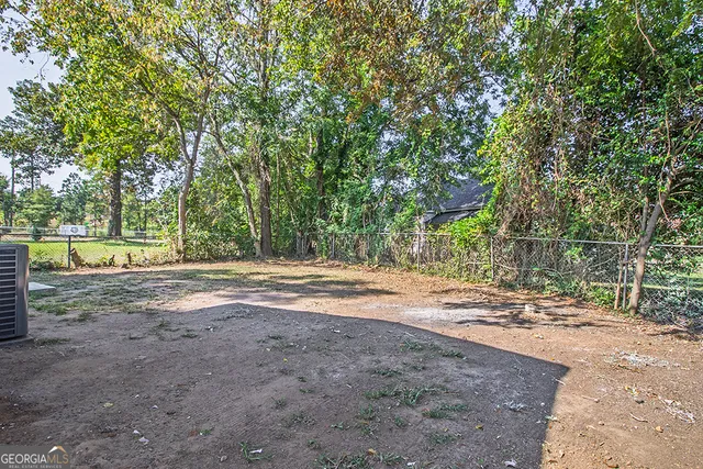 a view of a yard with large trees