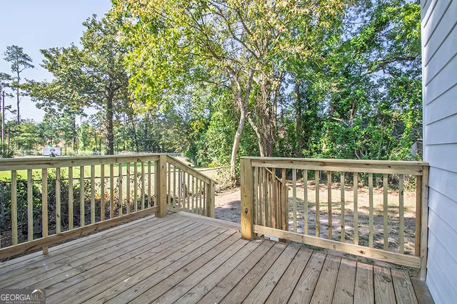 a view of balcony with wooden floor and fence